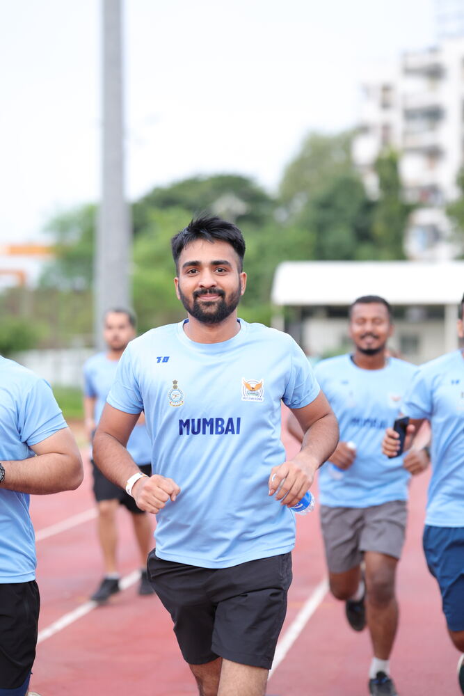 Runner in Mumbai jersey smiling during training run